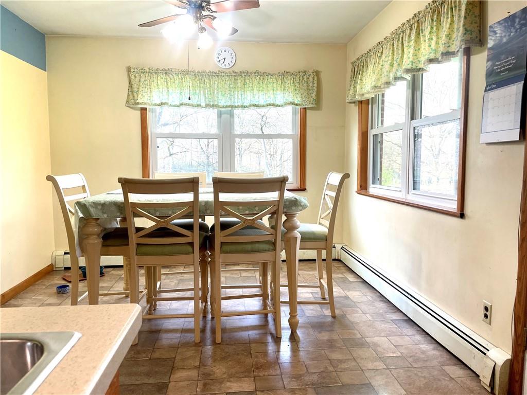 472 West Sunbury Road Butler, PA 16001 - Photo 11 of 39 a dining room with wooden floor a chandelier a glass table and chairs
