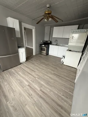 a bedroom with a bed and a refrigerator