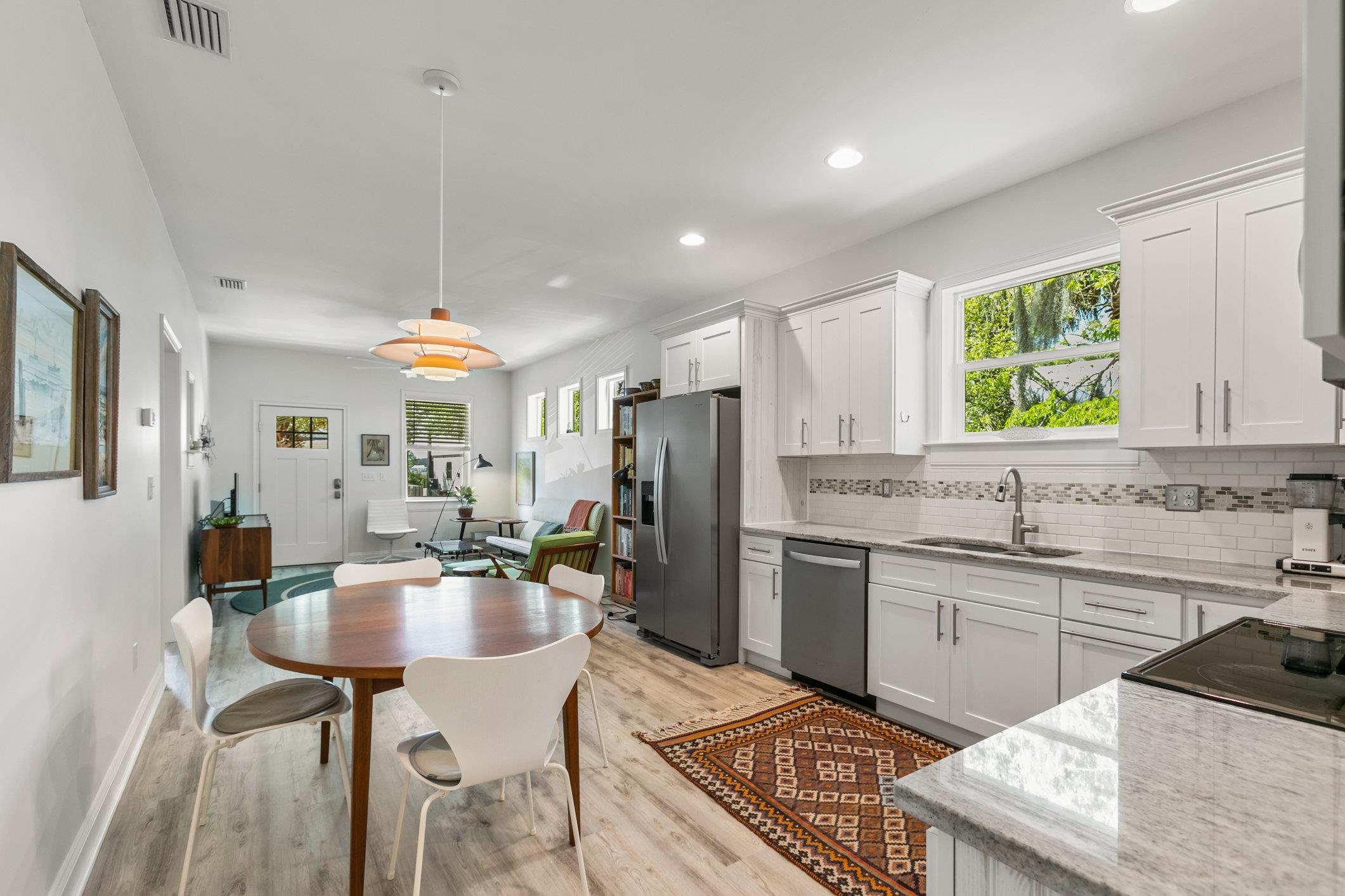 249 Riberia Street St. Augustine, FL 32084 - Photo 11 of 45 a kitchen with a table chairs sink and refrigerator