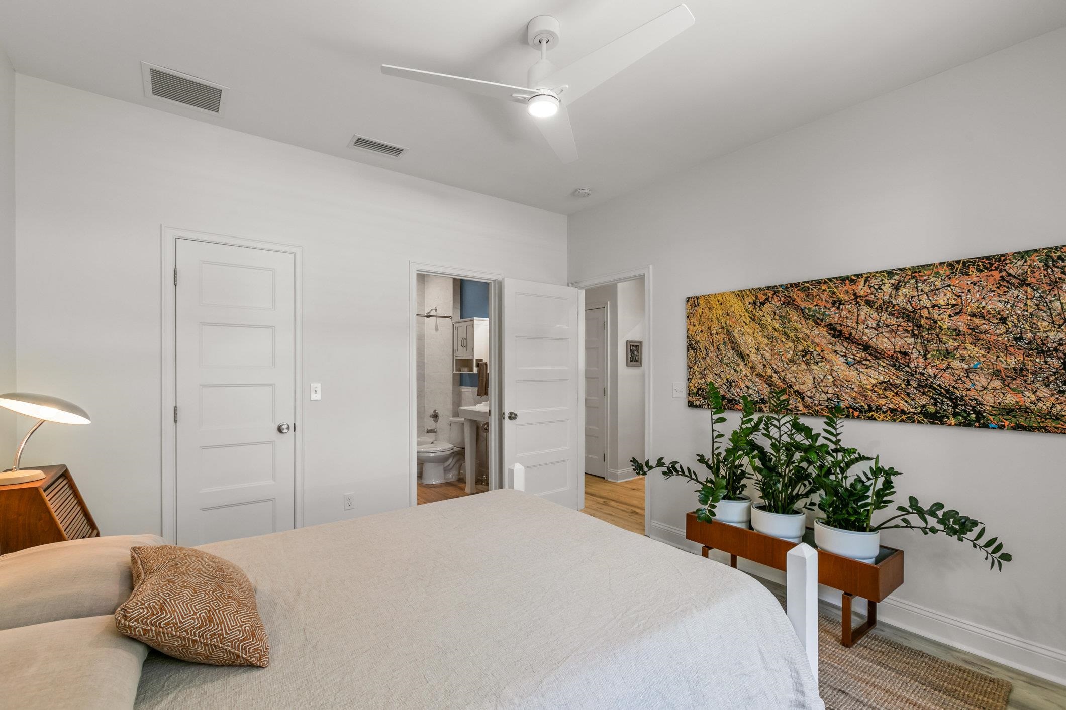 249 Riberia Street St. Augustine, FL 32084 - Photo 16 of 45 a bedroom with a bed and a potted plant