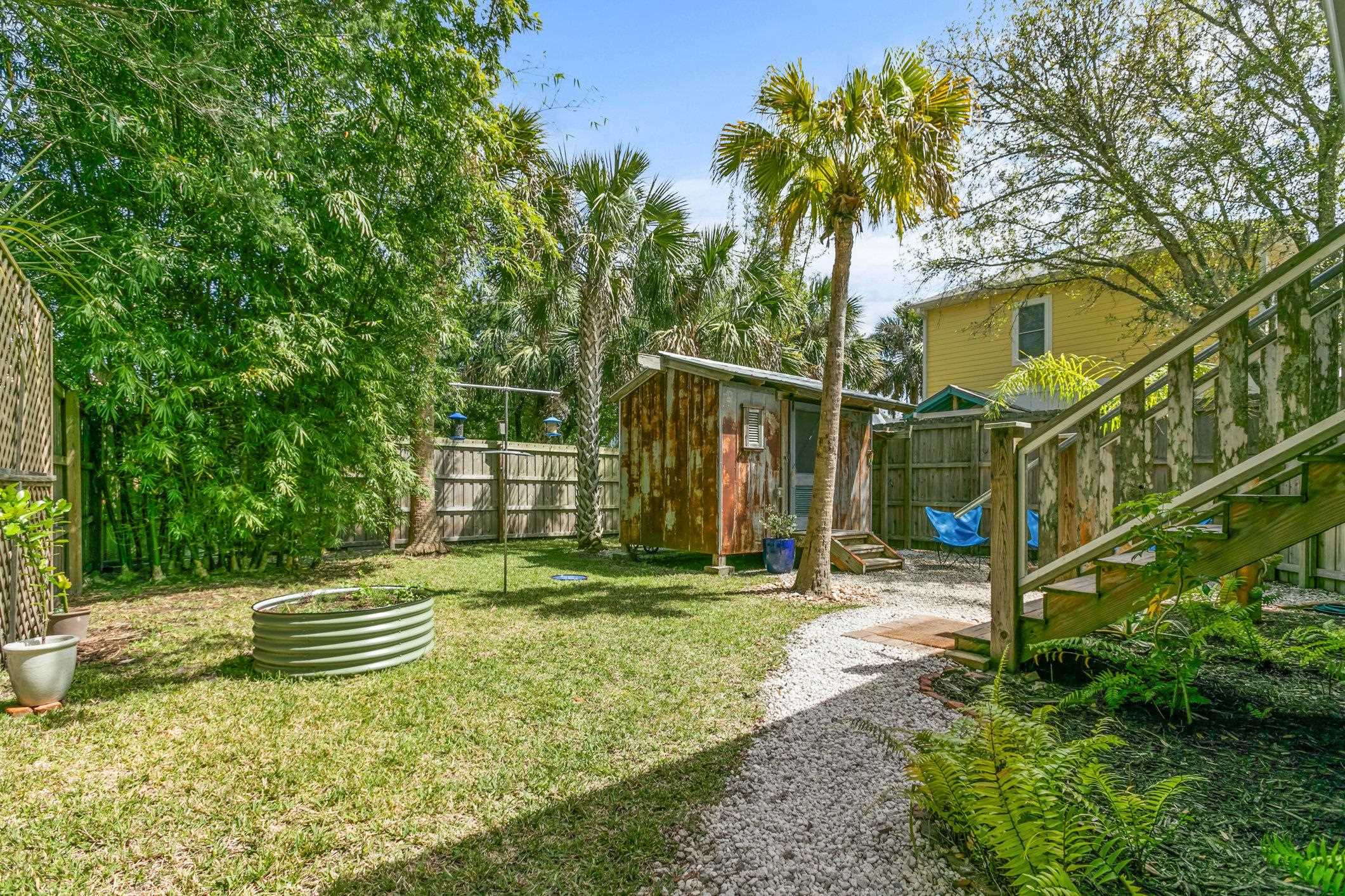 249 Riberia Street St. Augustine, FL 32084 - Photo 32 of 45 a backyard of a house with table and chairs