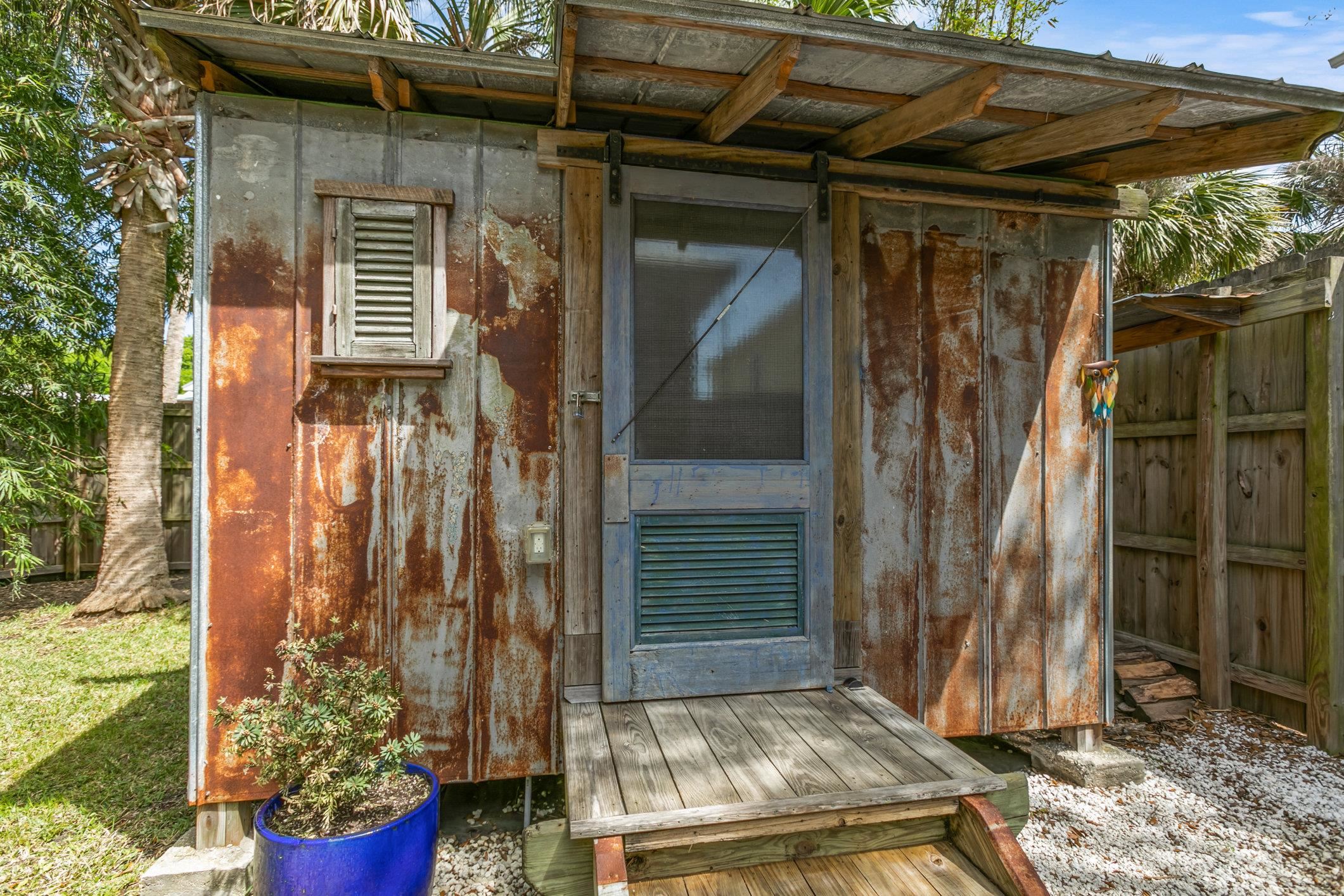 249 Riberia Street St. Augustine, FL 32084 - Photo 36 of 45 a view of a house with a small yard and wooden floor and a chair