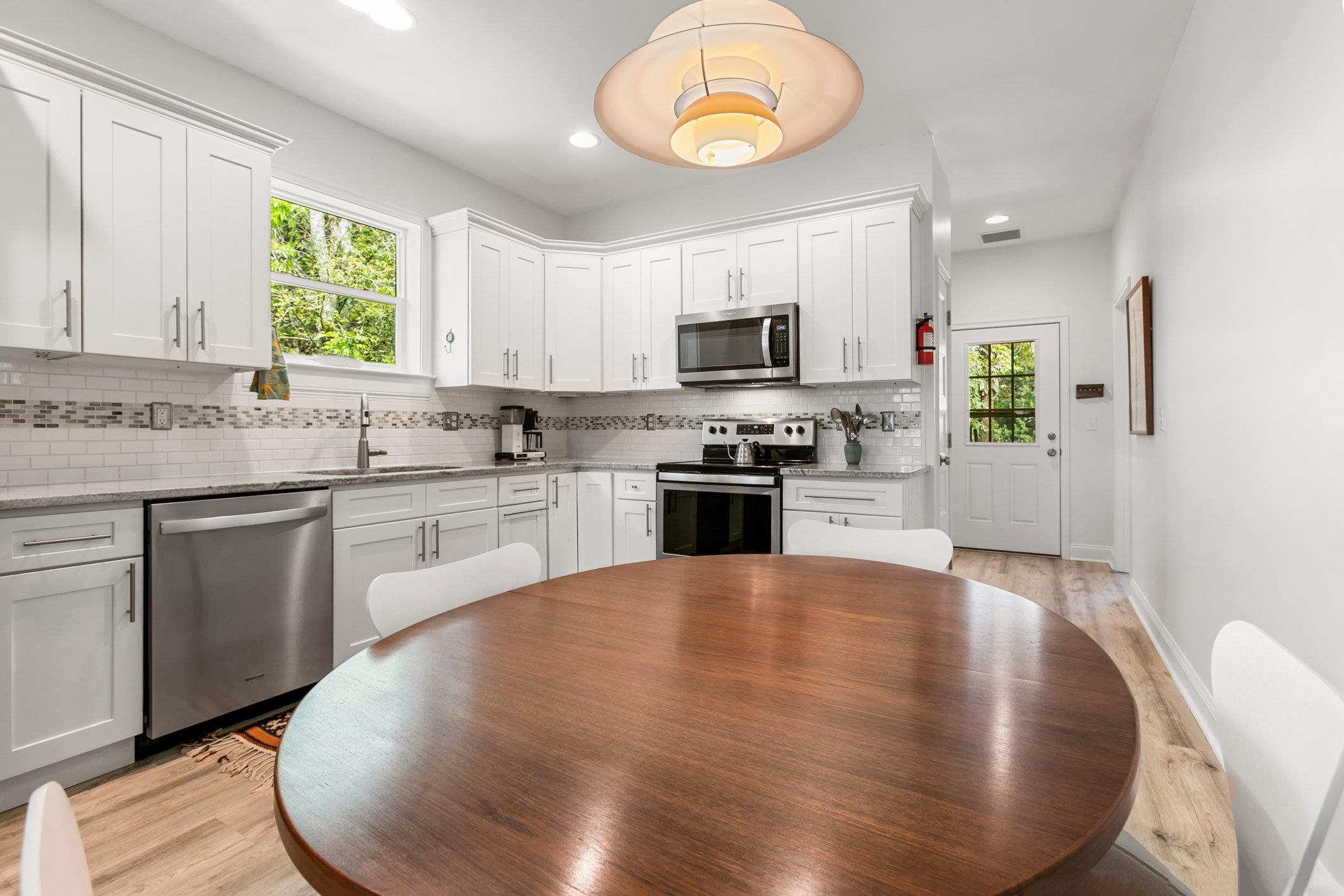 249 Riberia Street St. Augustine, FL 32084 - Photo 8 of 45 a large kitchen with a stove a sink dishwasher and a refrigerator with wooden floor