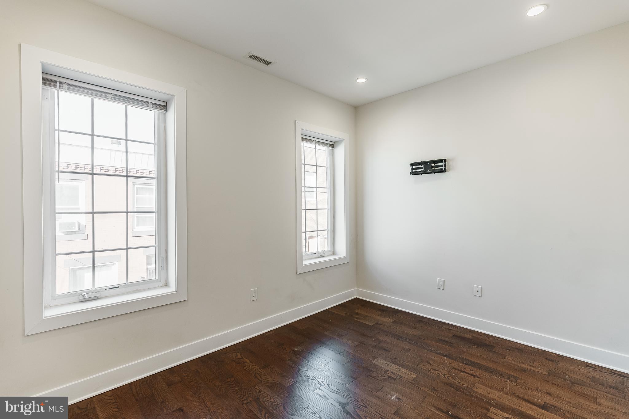 1331 South Dover Street Philadelphia, PA 19146 - Photo 20 of 24 an empty room with wooden closet and windows