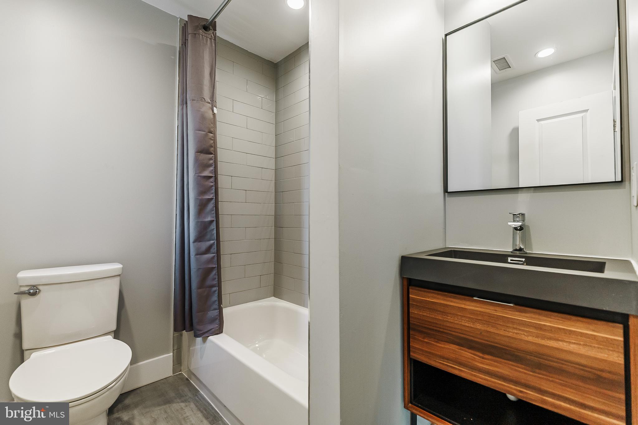 1331 South Dover Street Philadelphia, PA 19146 - Photo 23 of 24 a bathroom with a sink a toilet and shower