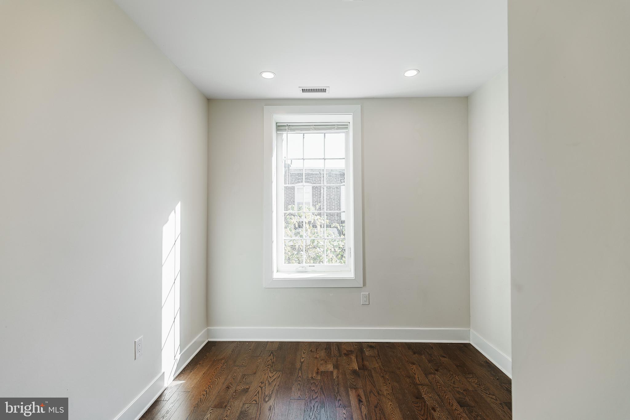 1331 South Dover Street Philadelphia, PA 19146 - Photo 3 of 24 a view of an empty room with wooden floor and a window