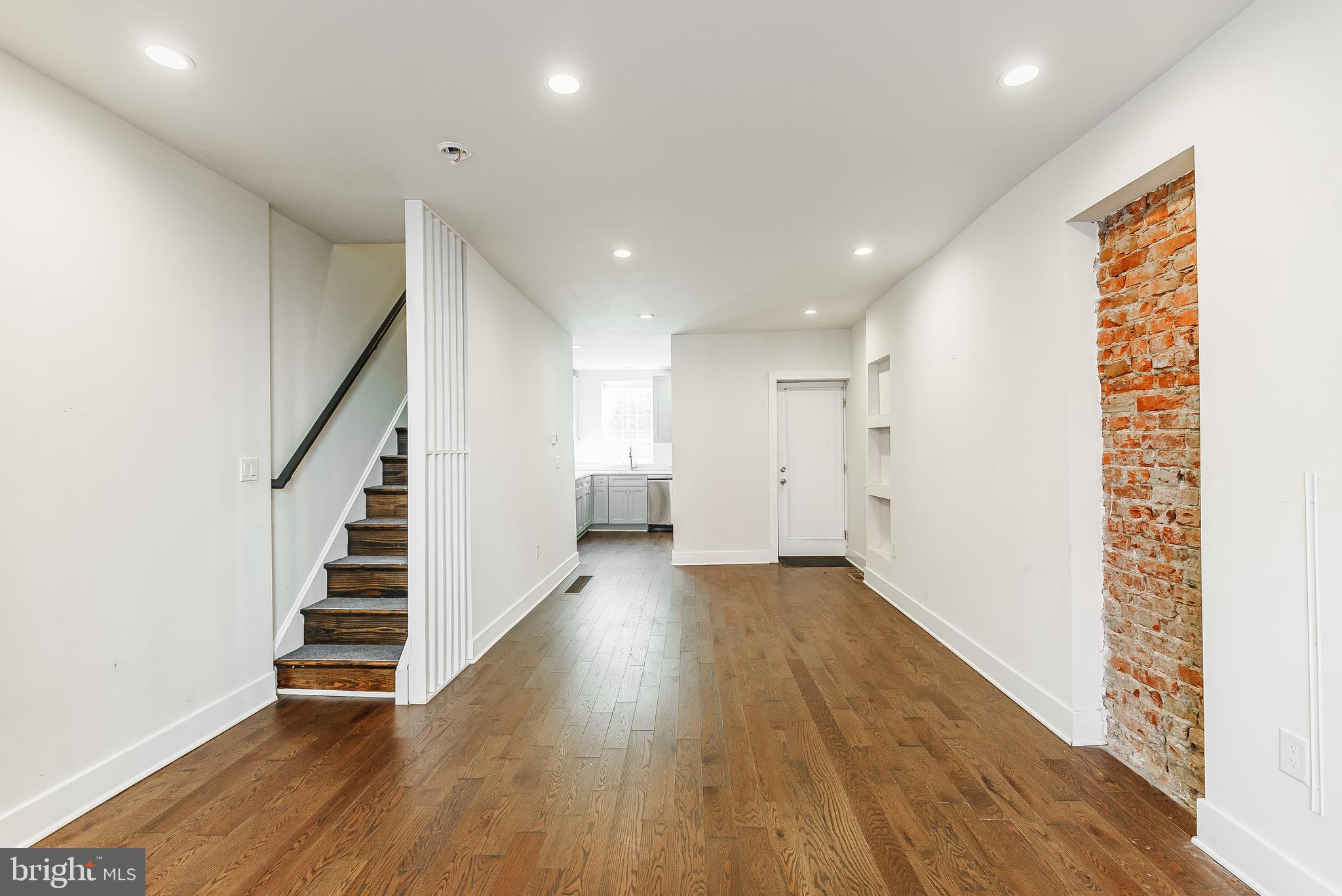 1331 South Dover Street Philadelphia, PA 19146 - Photo 4 of 24 a view of an empty room with wooden floor and stairs