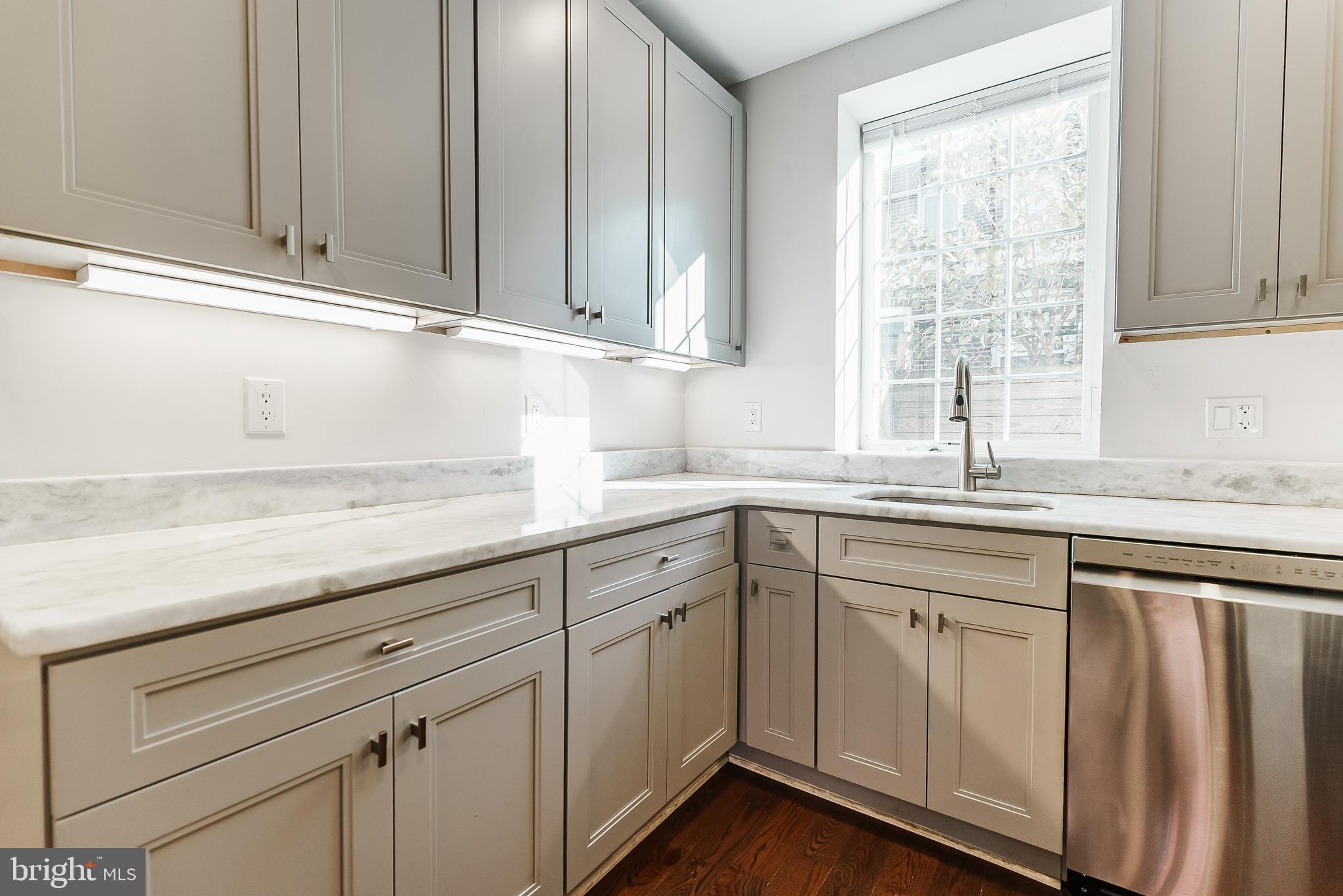 1331 South Dover Street Philadelphia, PA 19146 - Photo 8 of 24 a kitchen with granite countertop white cabinets and sink
