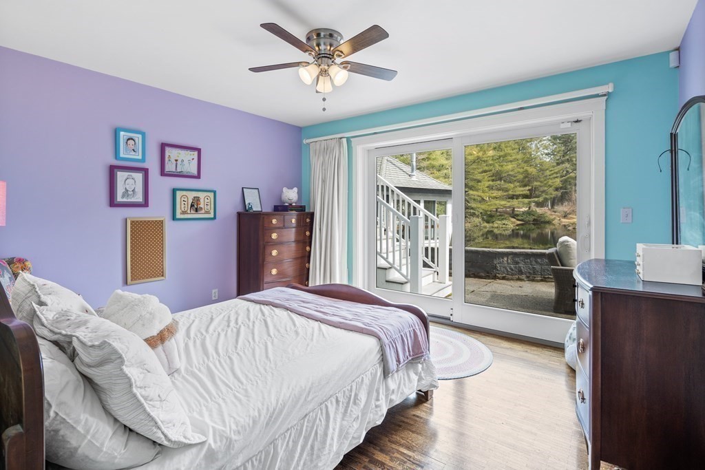 15 Forster Road Manchester, MA 01944 - Photo 31 of 42 a bedroom with a large bed and a chandelier