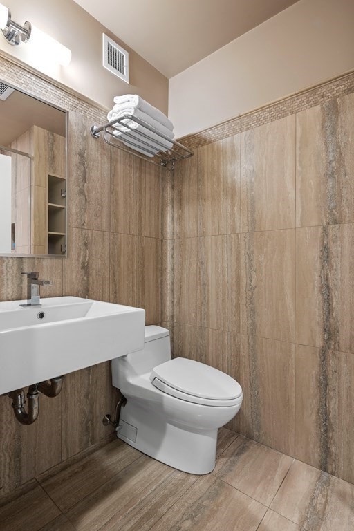 15 Forster Road Manchester, MA 01944 - Photo 33 of 42 a bathroom with a sink a toilet a mirror and shower curtain