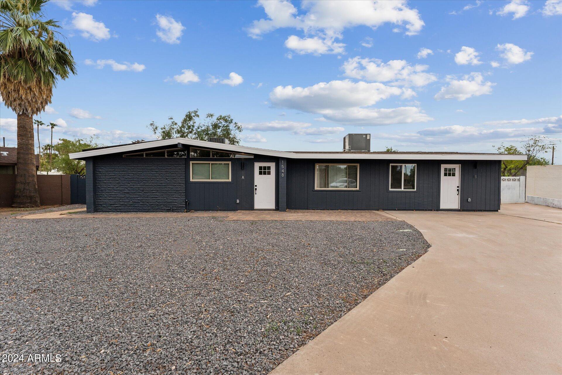 1548 North Upland Circle, Unit C Mesa, AZ 85201 - Photo 1 of 21 a front view of a house with a garden