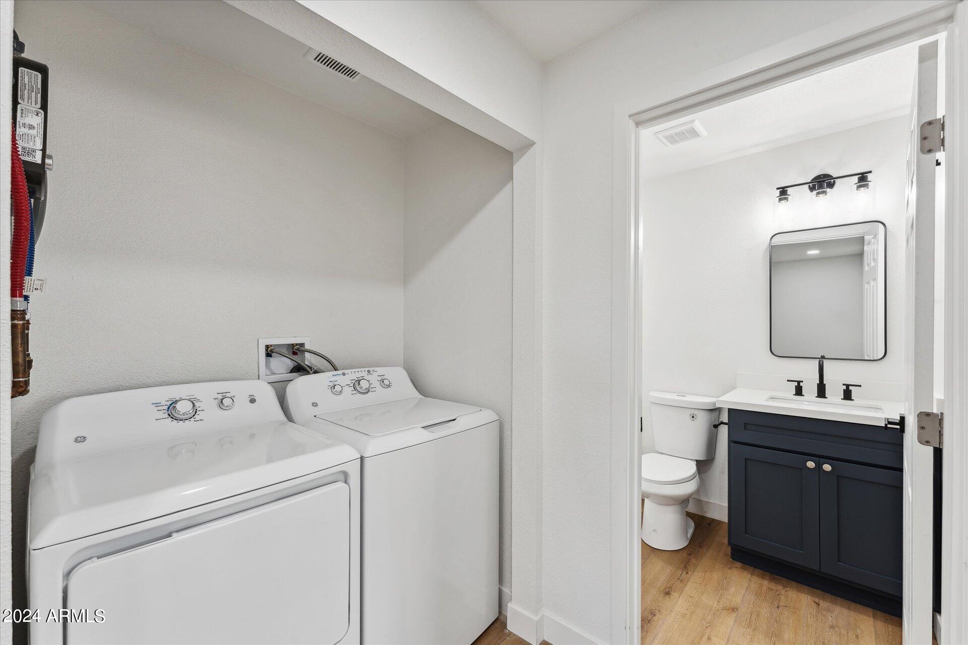 1548 North Upland Circle, Unit C Mesa, AZ 85201 - Photo 17 of 21 a bathroom with a toilet sink and mirror