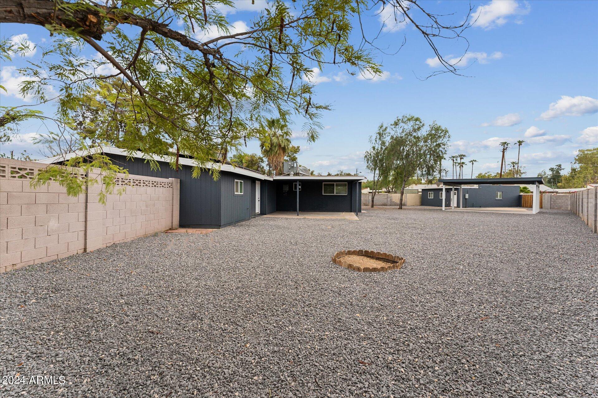 1548 North Upland Circle, Unit C Mesa, AZ 85201 - Photo 20 of 21 a front view of a house with a yard