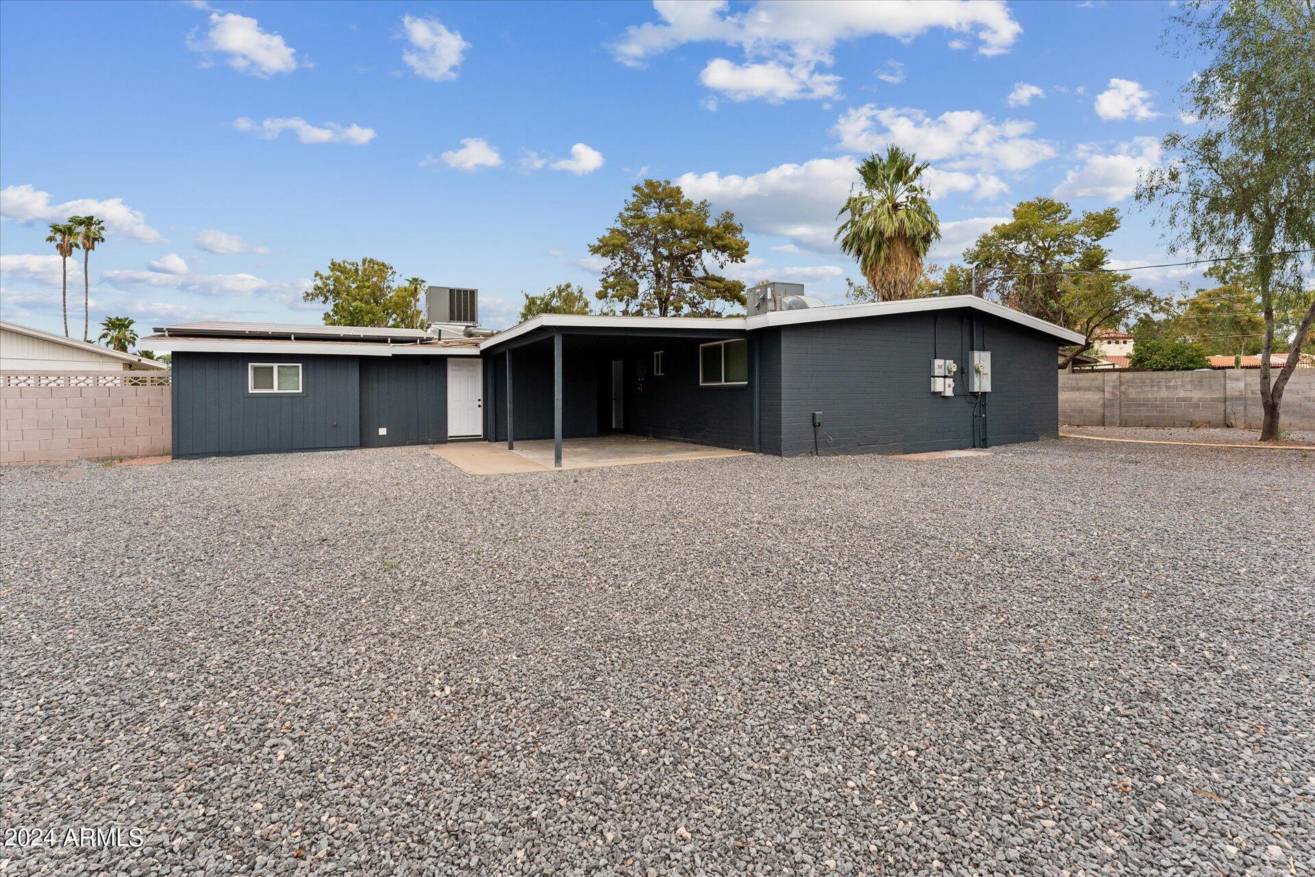 1548 North Upland Circle, Unit C Mesa, AZ 85201 - Photo 21 of 21 a front view of a house with a yard