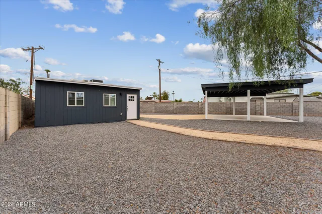 a view of a house with a backyard and garage