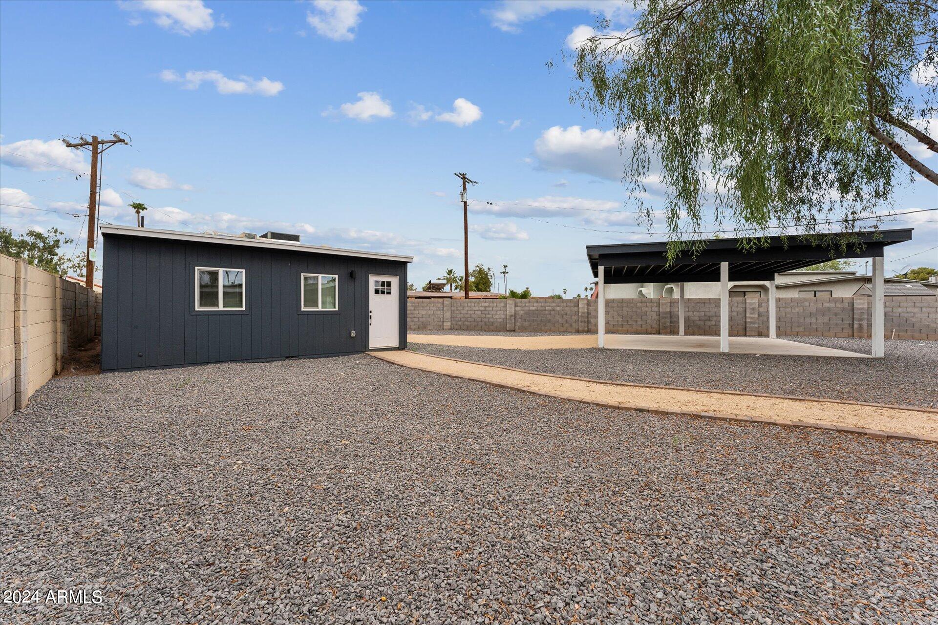 1548 North Upland Circle, Unit C Mesa, AZ 85201 - Photo 3 of 21 a view of a house with a backyard and garage