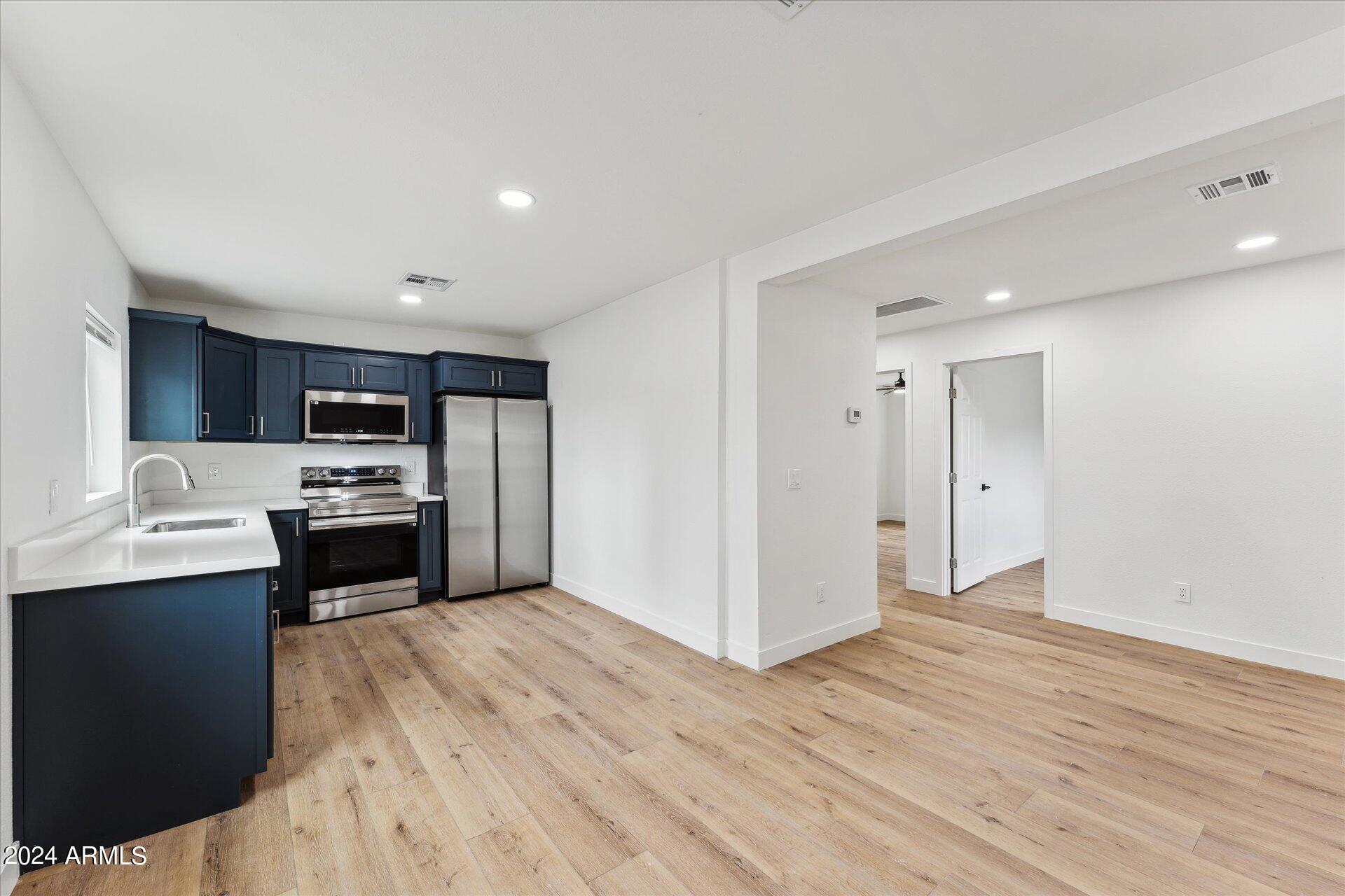 1548 North Upland Circle, Unit C Mesa, AZ 85201 - Photo 8 of 21 a kitchen with a refrigerator and a stove top oven
