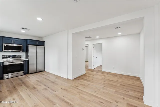 a view of a kitchen with a sink and a refrigerator