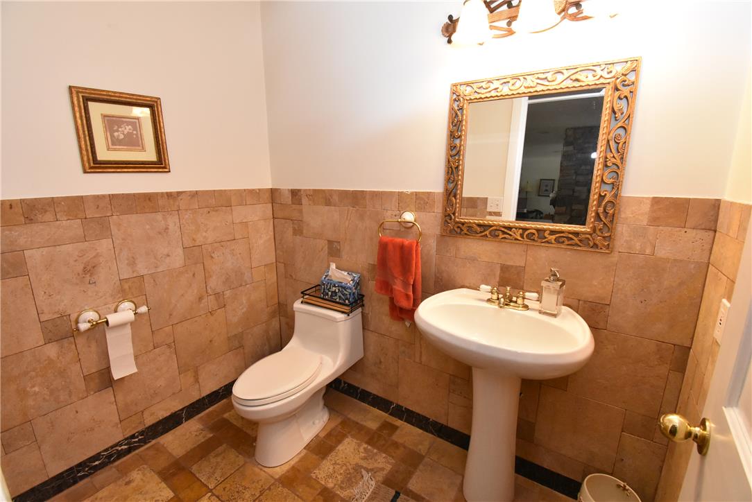 424 Grape Street Whitehall, PA 18052 - Photo 22 of 50 This powder room features elegant tile work, a classic pedestal sink, and decorative fixtures.