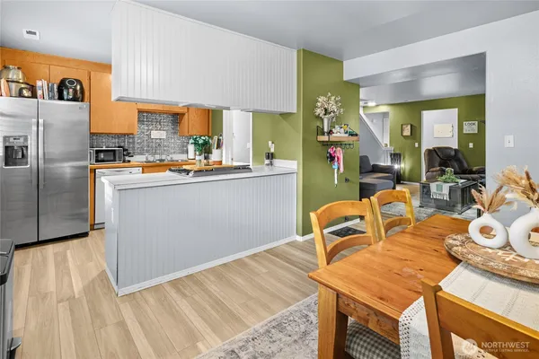 a kitchen with granite countertop a sink appliances and cabinets