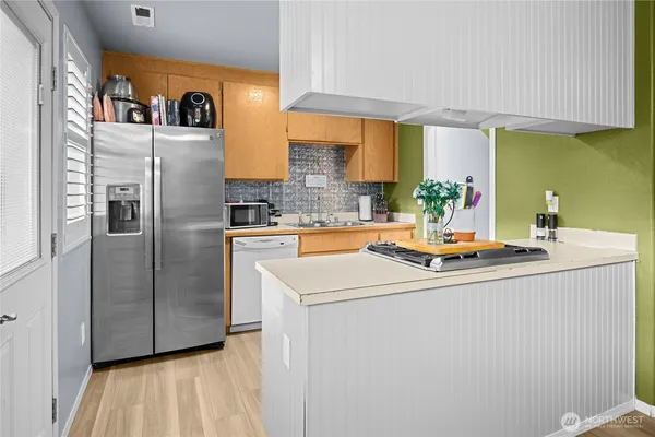 a kitchen with stainless steel appliances a sink and a refrigerator