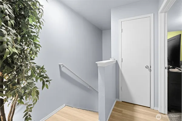 a view of hallway with wooden floor