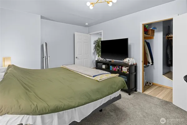 a bedroom with a bed and a flat screen tv