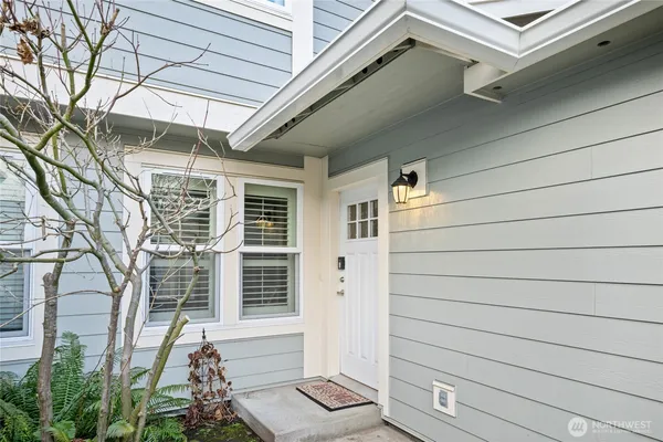 a view of backyard with a tub and wooden fence