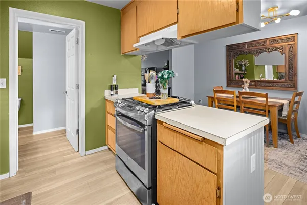 a kitchen that has a stove and a table