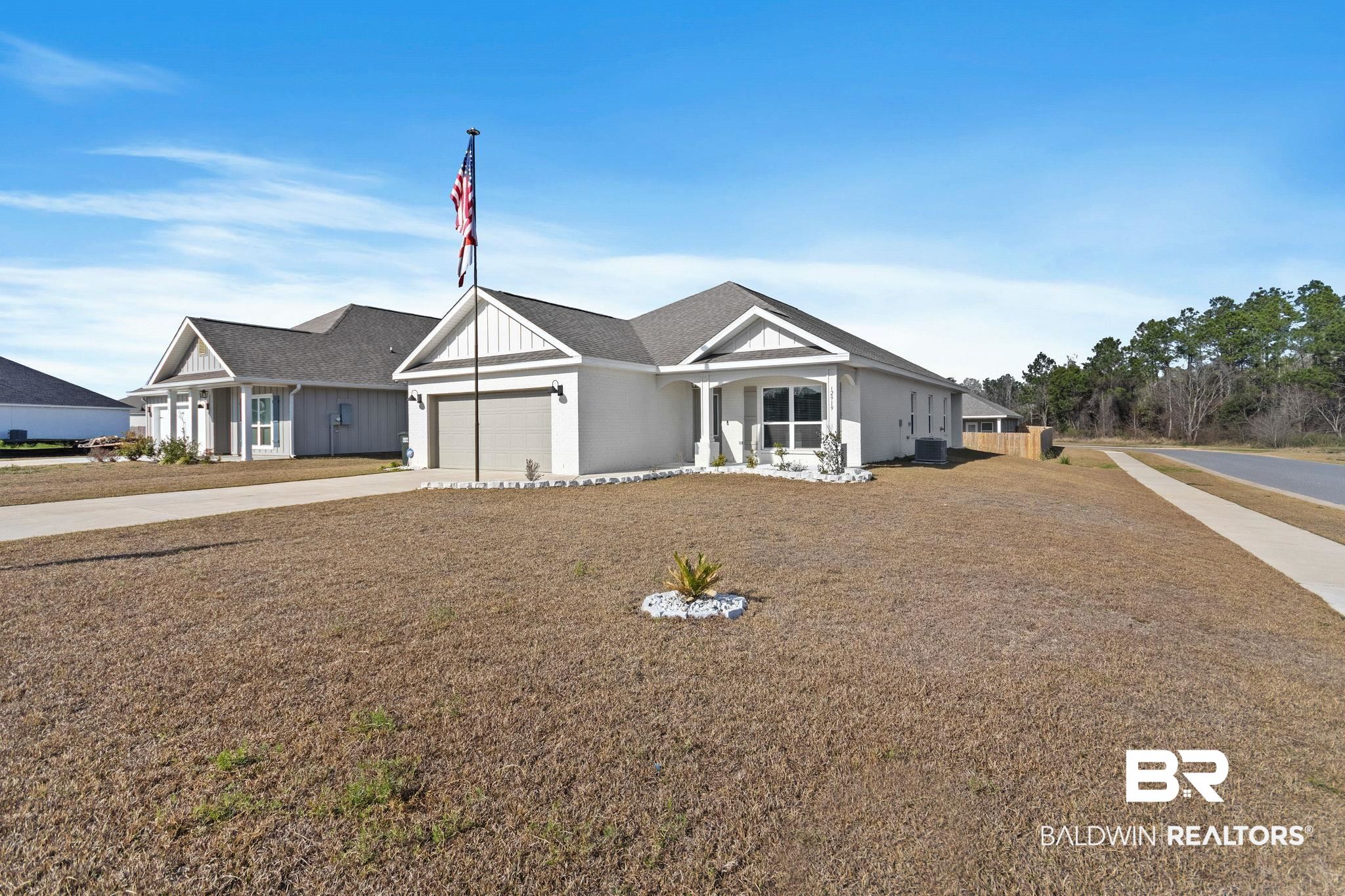 12919 Torrent Road Fairhope, AL 36532 - Photo 4 of 74 View of front of house featuring an attached garage, concrete driveway, and a shingled roof