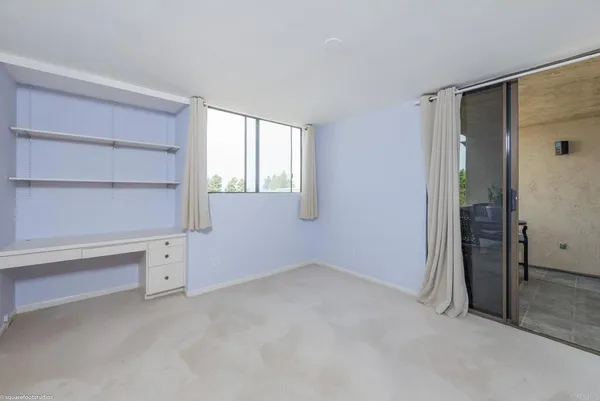 an empty room with a empty space and windows