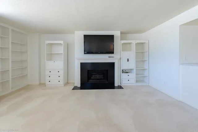 a view of a livingroom with an empty space and a fireplace