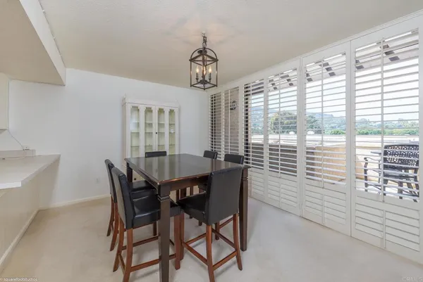 a view of a dining room with furniture and window