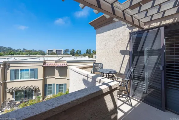 a view of a balcony with chairs