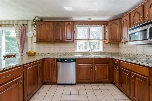126 North Branch Road Concord, MA 01742 - Photo 7 of 22 a kitchen with stainless steel appliances granite countertop a sink stove and cabinets