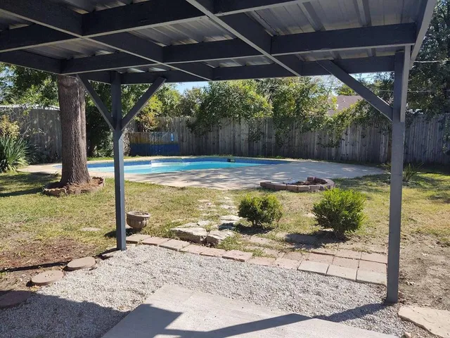 a view of a backyard of the house