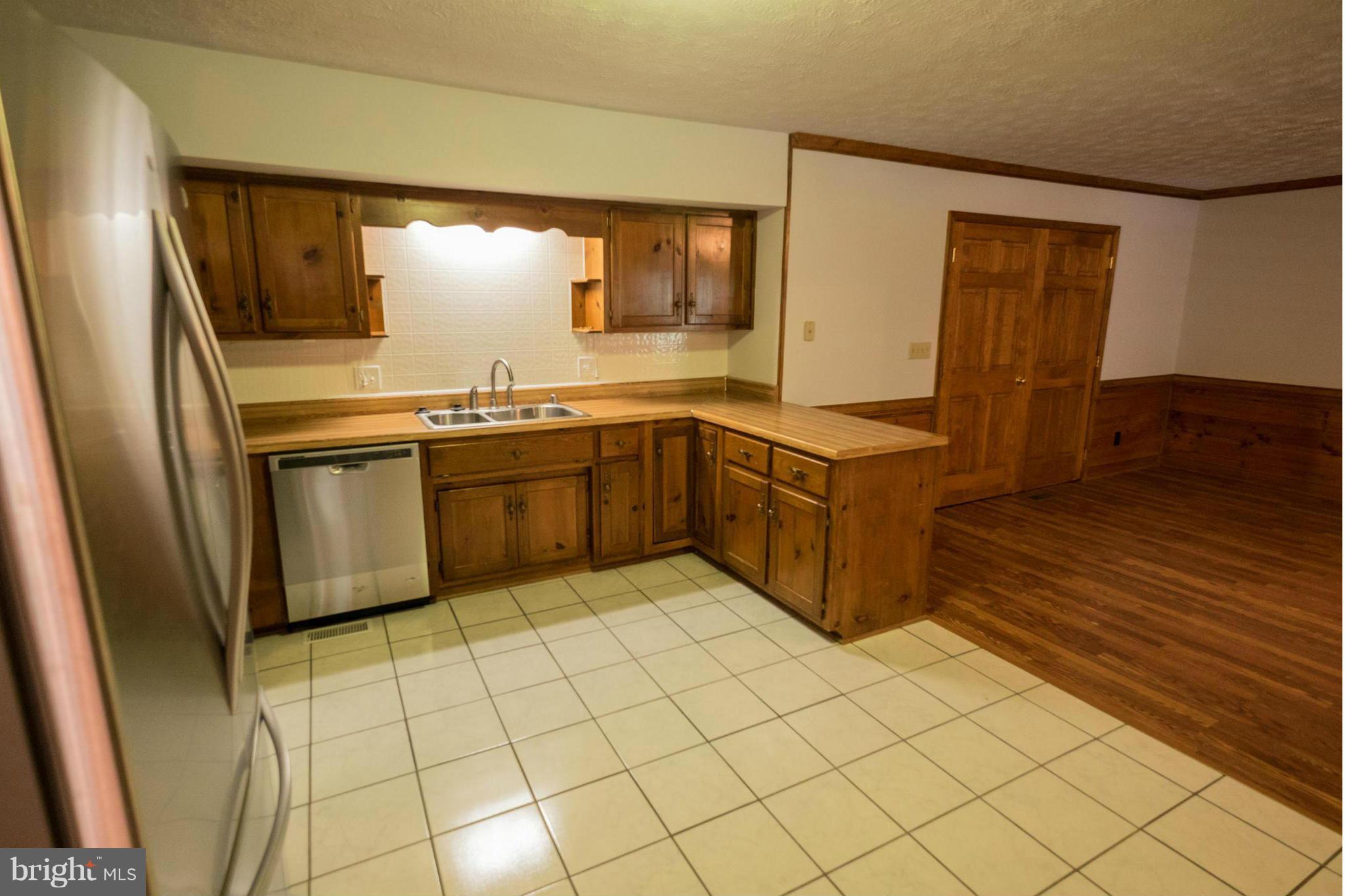 2034 Coast Guard Drive Stafford, VA 22554 - Photo 11 of 30 a kitchen with stainless steel appliances granite countertop a sink and cabinets