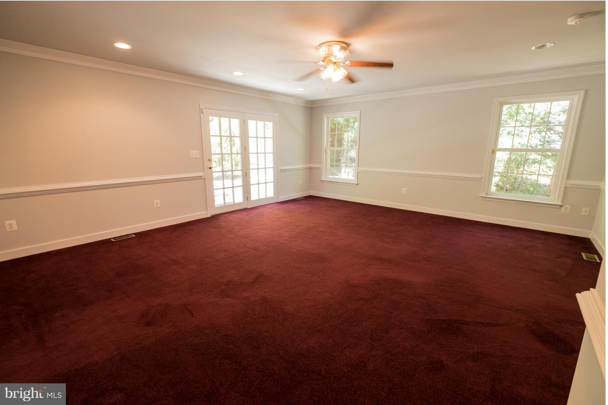 2034 Coast Guard Drive Stafford, VA 22554 - Photo 14 of 30 an empty room with windows and ceiling fan