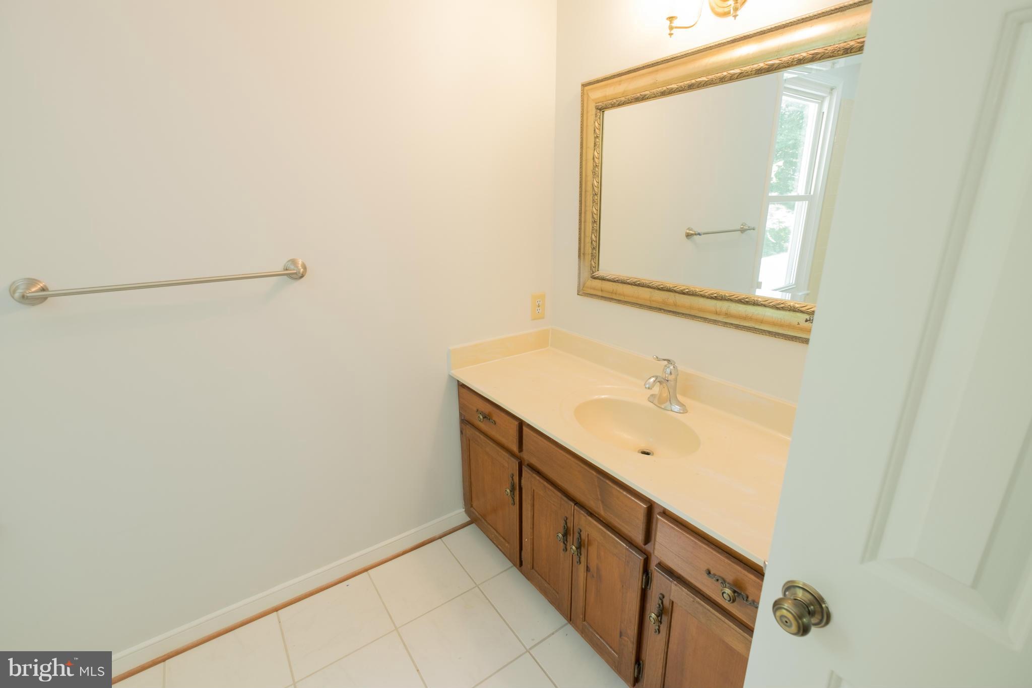 2034 Coast Guard Drive Stafford, VA 22554 - Photo 20 of 30 a bathroom with a sink and a mirror