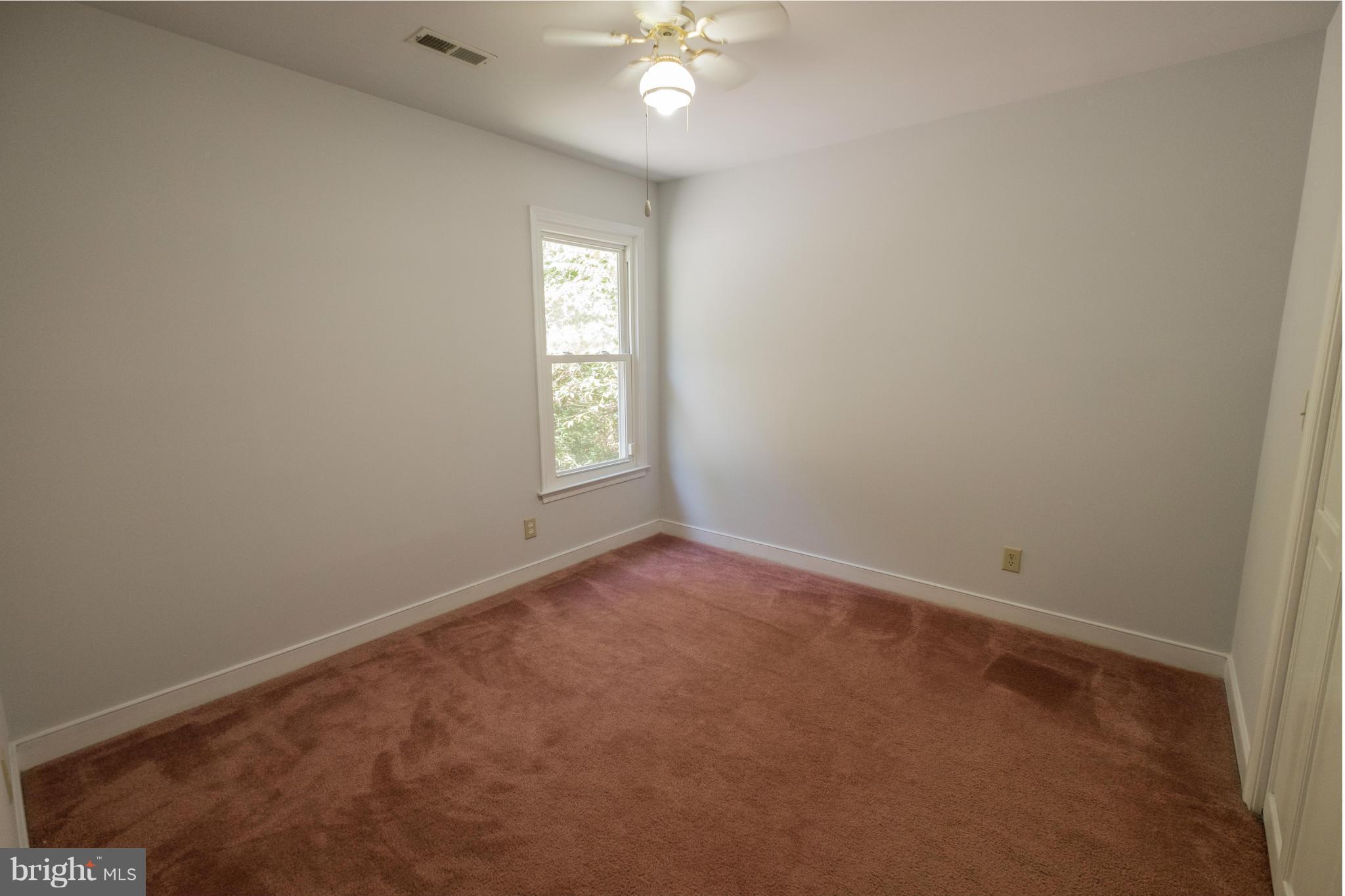 2034 Coast Guard Drive Stafford, VA 22554 - Photo 24 of 30 an empty room with windows and chandelier fan