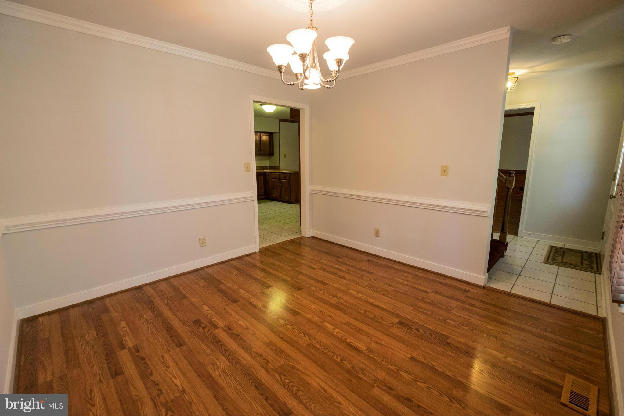2034 Coast Guard Drive Stafford, VA 22554 - Photo 4 of 30 a view of an empty room with wooden floor and a window
