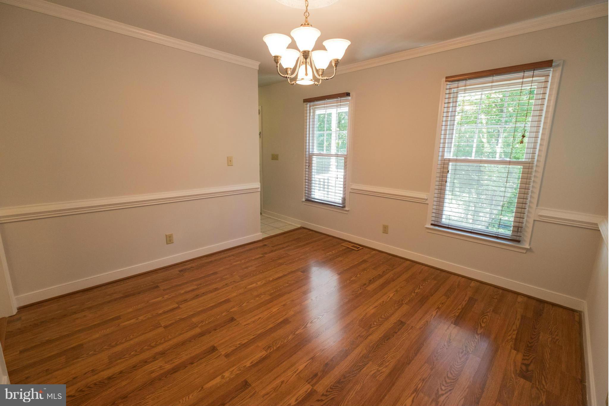 2034 Coast Guard Drive Stafford, VA 22554 - Photo 5 of 30 a view of an empty room with wooden floor and a window