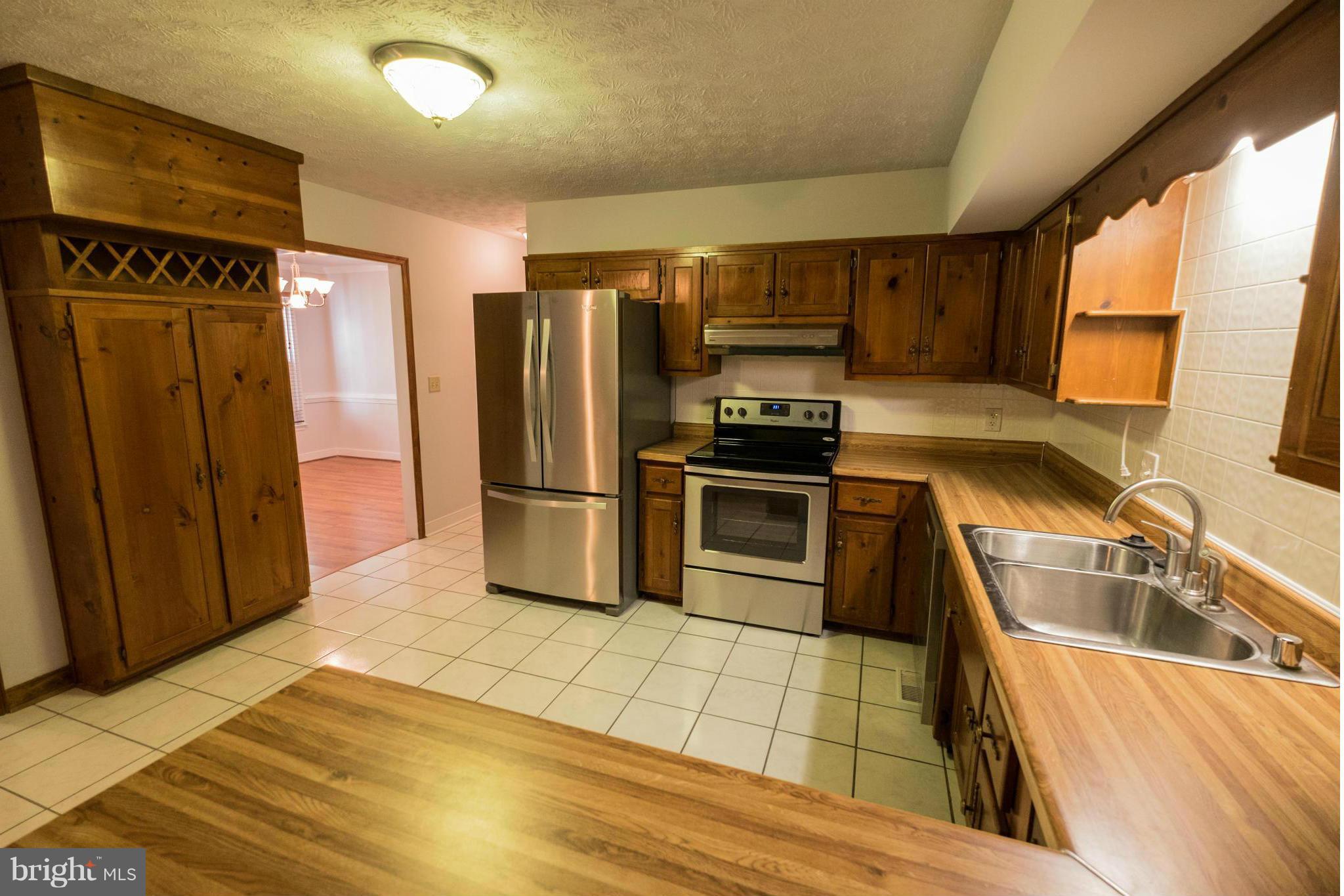 2034 Coast Guard Drive Stafford, VA 22554 - Photo 10 of 30 a kitchen with granite countertop a refrigerator and a sink