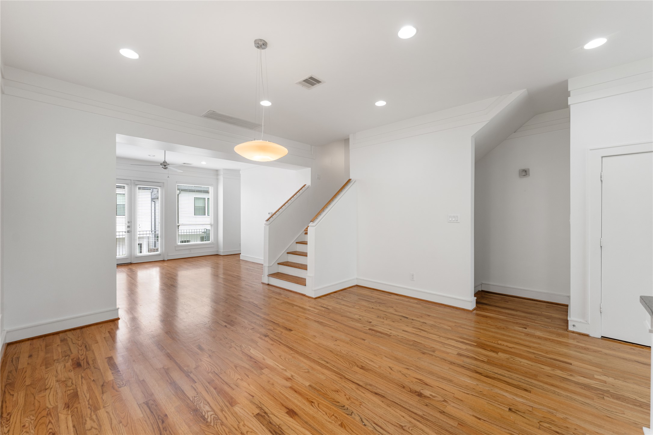 6112 Tyne Street, Unit B Houston, TX 77007 - Photo 16 of 33 a view of an empty room with wooden floor and stairs