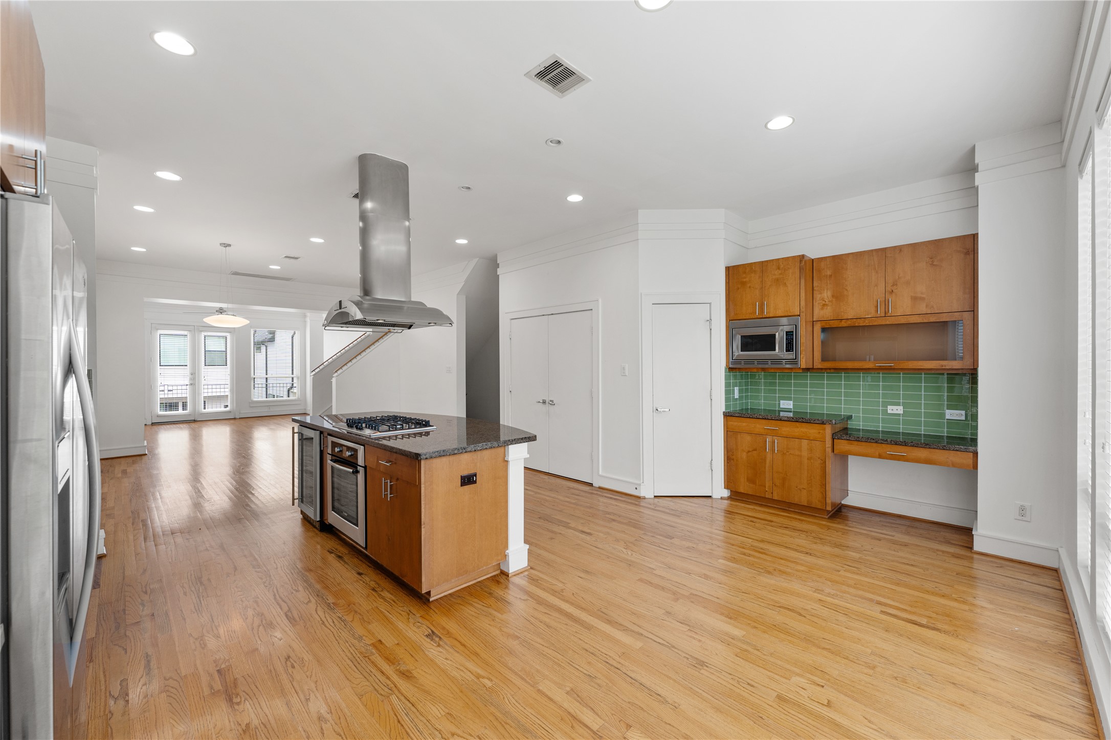 6112 Tyne Street, Unit B Houston, TX 77007 - Photo 3 of 33 a kitchen with stainless steel appliances kitchen island wooden cabinets and wooden floor