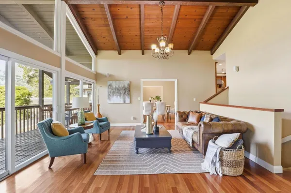 a dining room with furniture potted plants and wooden floor