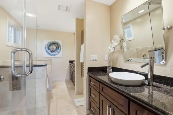 an aerial view of residential house with outdoor space and trees all around