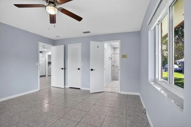 a view of an entryway with a chandelier fan