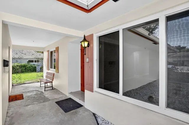 a view of a hallway with a glass door and glass door