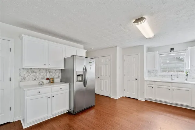 a kitchen with white cabinets and stainless steel appliances